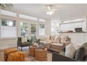Sunlit living room with plush seating, natural light, and access to outdoor space at 300 Hudson St # 109, Denver, CO 80220