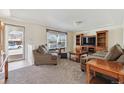 Bright living room features large windows and comfy seating at 7447 Quay St, Arvada, CO 80003