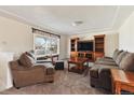 Spacious living room with neutral carpeting and wood furniture at 7447 Quay St, Arvada, CO 80003