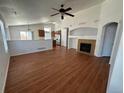 Spacious living room featuring hardwood floors, a cozy fireplace, and an open layout that flows into the kitchen at 20148 E Dartmouth Dr, Aurora, CO 80013