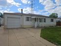 Single-story home featuring an attached garage, neat landscaping, and a welcoming front entrance at 3905 Nelson St, Wheat Ridge, CO 80033
