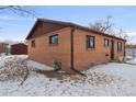 Side view of brick ranch home with shed at 7600 Monaco St, Commerce City, CO 80022