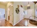 Inviting foyer with hardwood floors, a coat closet, and a decorative wreath at 2265 S Depew St, Denver, CO 80227