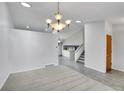 Open concept living space with tile flooring, stairs, and natural lighting at 12366 Elm Way, Thornton, CO 80241