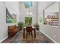 Bright dining room features high ceilings, modern chandelier, and stylish decor providing an elegant space for gatherings at 531 Americana Rd, Longmont, CO 80504