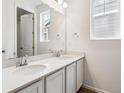 Well-lit bathroom showcasing a double vanity with modern chrome faucets and a large mirror at 39171 Anthony St, Elizabeth, CO 80107