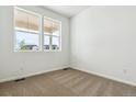 Cozy bedroom featuring neutral carpet, bright window, and a fresh coat of white paint at 39171 Anthony St, Elizabeth, CO 80107
