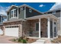 Beautiful two-story home with stone accents, covered porch and well-maintained landscaping at 4431 N Quatar Ct, Aurora, CO 80019