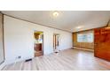 Spacious living room with bright floors connecting to the kitchen area at 598 S Navajo St, Denver, CO 80223