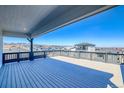 Expansive outdoor balcony with wooden floors and dark railings offers panoramic mountain views at 8509 Orchard City Dr, Littleton, CO 80125