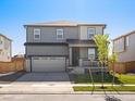Charming two-story home with a well-manicured lawn, front porch, and two car garage at 8850 Sedalia St, Commerce City, CO 80022