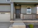 Covered front porch with stone accents on a modern, two-story home at 8850 Sedalia St, Commerce City, CO 80022