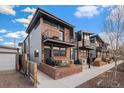 Modern townhouse exterior with brick facade, metal accents, and private balconies at 2466 S Delaware St # 3, Denver, CO 80223