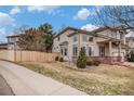 Charming two-story home with a covered porch and well-maintained landscaping at 4501 Whitehall Ln, Highlands Ranch, CO 80126