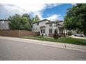 Charming two-story home with a large window and a well-manicured lawn at 4501 Whitehall Ln, Highlands Ranch, CO 80126