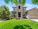 Stunning two-story home with stone accents, a well-maintained lawn, and professional landscaping at 13645 Osage Ct, Broomfield, CO 80023
