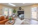 Inviting living room featuring a fireplace, comfortable seating, and ample natural light at 3098 S Vine St, Denver, CO 80210