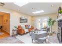 Cozy living room with skylights, a fireplace, and access to the backyard through glass doors at 3098 S Vine St, Denver, CO 80210