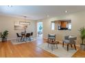 Bright and airy living room with hardwood floors, modern decor, and a view into the kitchen at 3098 S Vine St, Denver, CO 80210