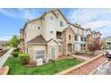 Attractive exterior view of a multi-story condo building featuring stone accents and well-maintained landscaping at 457 Black Feather Loop # 703, Castle Rock, CO 80104