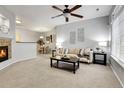 Inviting living room with neutral decor, plush carpeting, and a cozy fireplace at 457 Black Feather Loop # 703, Castle Rock, CO 80104