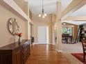 Grand foyer featuring hardwood floors, high ceilings, and elegant chandelier at 885 Sage Sparrow Cir, Highlands Ranch, CO 80129