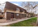 Charming townhome featuring a brick facade and landscaped entrance, creating a warm welcome at 7755 E Quincy Ave # T80, Denver, CO 80237