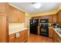 Efficient kitchen design with wooden cabinets and modern appliances, ideal for cooking at 7755 E Quincy Ave # T80, Denver, CO 80237