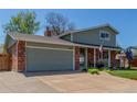Two-story home with brick accents, a well-maintained lawn, and a two car garage at 7367 Coors St, Arvada, CO 80005