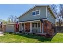 Charming two-story home with brick accents, manicured lawn, and a two car garage at 7367 Coors St, Arvada, CO 80005