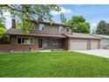 Charming home featuring a well-maintained lawn, brick accents and mature landscaping, enhancing its curb appeal at 7409 Mount Meeker Rd, Longmont, CO 80503