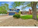 Charming home with stone and manicured grass in the front yard at 12355 E Arkansas Pl, Aurora, CO 80012