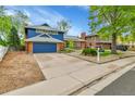 Charming two-story home with a well-manicured front yard and a spacious driveway at 12355 E Arkansas Pl, Aurora, CO 80012