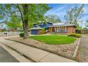 Charming home with stone and a grass yard next to the sidewalk at 12355 E Arkansas Pl, Aurora, CO 80012