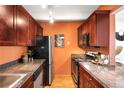 Updated kitchen boasts granite countertops, stainless steel appliances, and wood cabinets at 1365 Columbine St # 301, Denver, CO 80206
