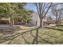 A well-maintained home exterior featuring green lawns and mature trees, showcasing the property's curb appeal and landscaping at 7998 S Wabash Ct, Centennial, CO 80112