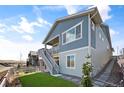 Charming home with a private entrance, blue siding, white trim and a cozy, inviting outdoor space at 8346 Mount Kataka St, Littleton, CO 80125