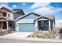 Charming single-Gathering home featuring a blue exterior, two-car garage, and well-manicured front yard at 8346 Mount Kataka St, Littleton, CO 80125