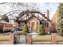 Charming brick home with a wood-trimmed exterior and manicured lawn at 1275 S Elizabeth St, Denver, CO 80210