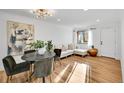 Stylish living space featuring an elegant dining set, white sofa, and wood flooring at 5211 W 4Th Ave # C, Lakewood, CO 80226