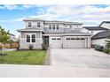 Beautiful two-story home featuring gray siding, stone accents, a three-car garage, and a well-manicured front lawn at 3091 Keepsake Way, Castle Rock, CO 80109