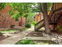 Exterior view showcases a well-manicured lawn and mature trees at 2261 S Buckley Rd # 102, Aurora, CO 80013
