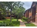 Exterior view of the property featuring well-maintained landscaping and charming wood accents throughout the complex at 2261 S Buckley Rd # 102, Aurora, CO 80013