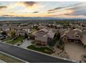 Expansive aerial view showcases the community, rolling hills, mountain views and the home's prime location within the neighborhood at 10783 Backcountry Dr, Highlands Ranch, CO 80126