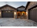 Beautiful stone-clad home with a three-car garage, gated entrance, and meticulously maintained landscaping showcasing the curb appeal at 10783 Backcountry Dr, Highlands Ranch, CO 80126