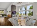 Bright living room with large windows, a modern fireplace, and stylish decor with views of nature at 6803 Snowshoe Trl, Evergreen, CO 80439