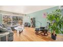 Inviting living room with wood floors, comfortable seating and sliding glass doors to a cozy balcony at 1223 Race St # 402, Denver, CO 80206