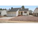 Charming single-Gathering home with a two-car garage, mature trees, and nicely landscaped front yard at 7586 Chase St, Arvada, CO 80003