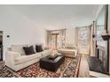 Comfortable living room with fireplace, hardwood floors, and abundant natural light at 7586 Chase St, Arvada, CO 80003