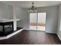 Dining room with sliding glass doors, wood floors, and a fireplace at 20000 E Mitchell Pl # 35, Denver, CO 80249